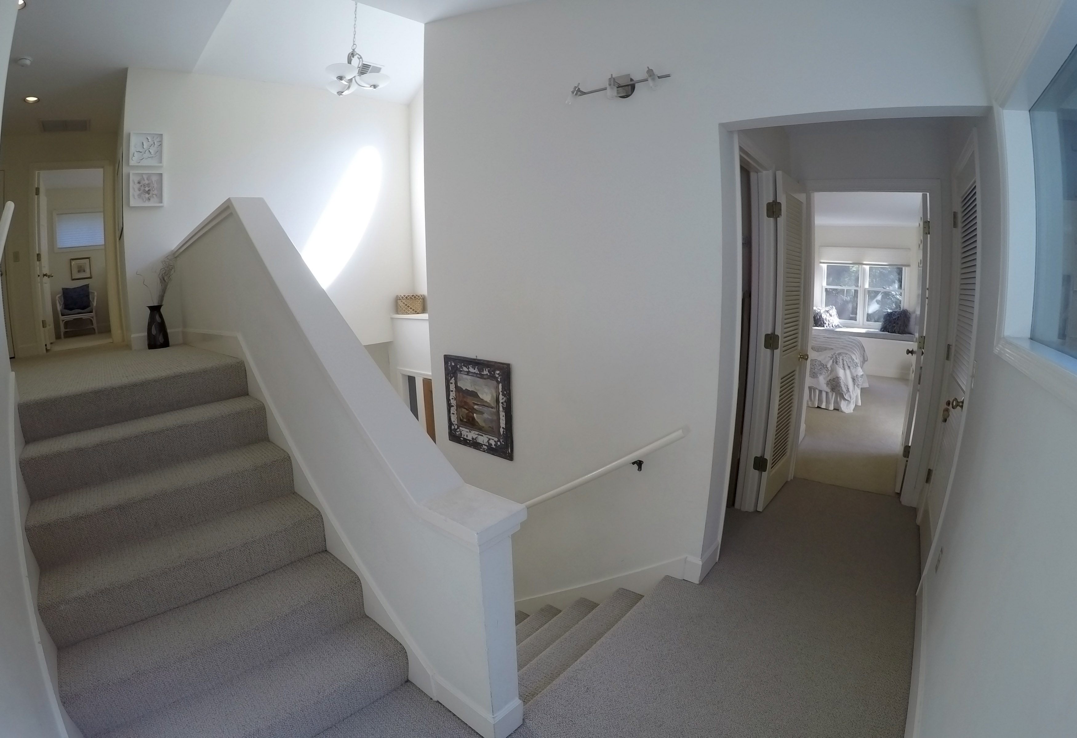 Hallway steps up to second level Master suite